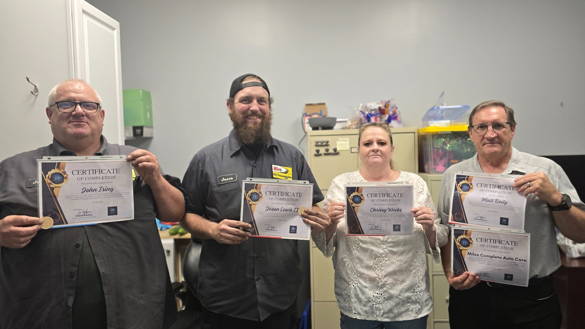 MDDR Enterprises team members holding certificates of completion from their Unbecoming at Work program